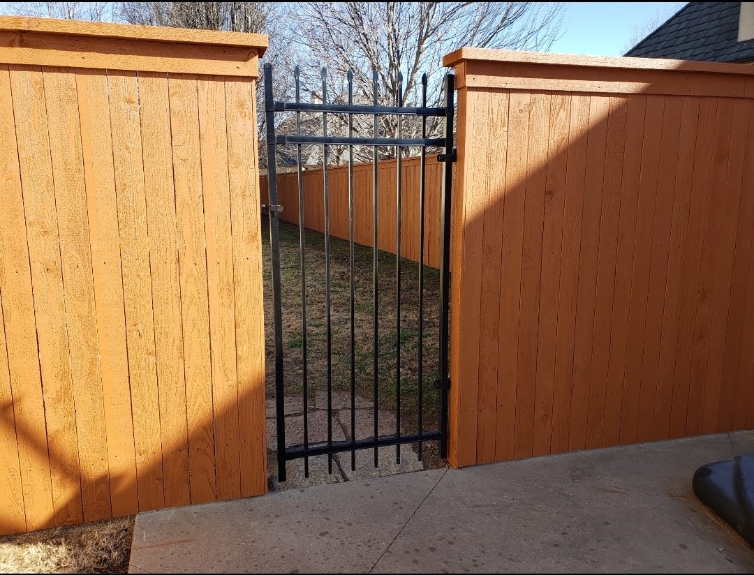 Fence staining with Solid color stain by The Tulsa Painters